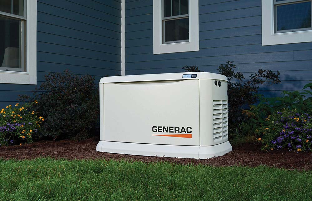 Generac standby generator installed outside a home with blue siding and landscaping