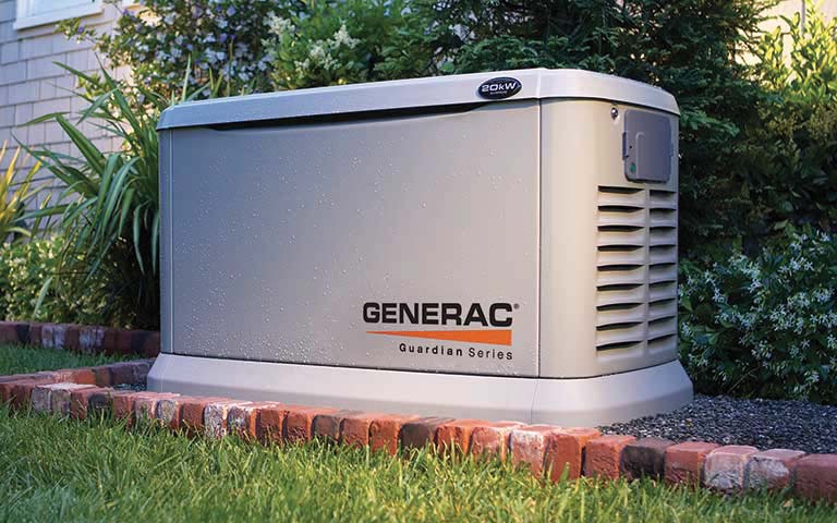 Generac Guardian Series standby generator installed outdoors on a brick base