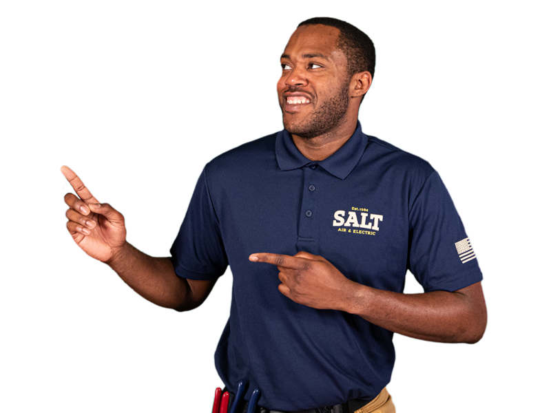 SALT technician in navy uniform smiling and pointing with both hands, demonstrating a friendly and approachable demeanor