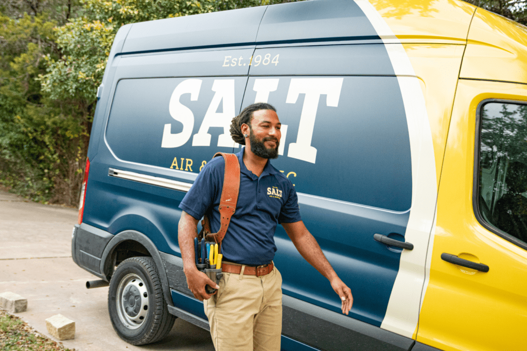 SALT HVAC tech next to business van.