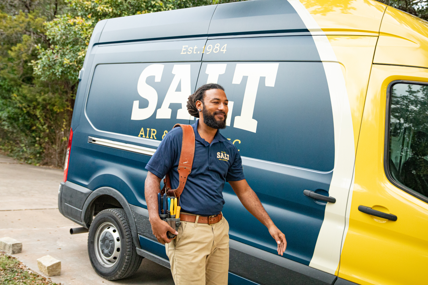 SALT HVAC tech next to business van.